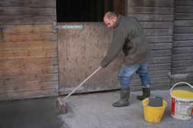 image of man applying ka tanking slurry to floor