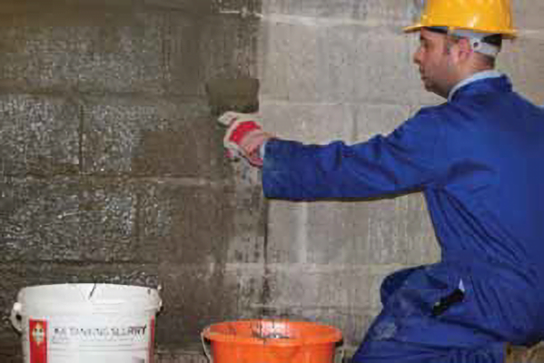 image of man applying tanking slurry to wall