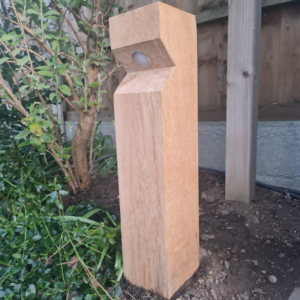 image of the stratton single wooden bollard light with leds in situ - oak wood