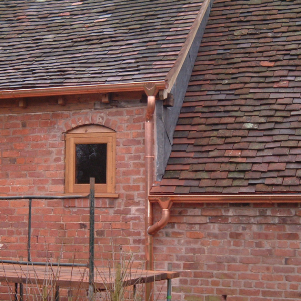 photograph showing copper downpipe bends and copper downpipe branch round installed