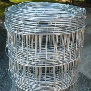 a close up picture of wire stock fencing with background