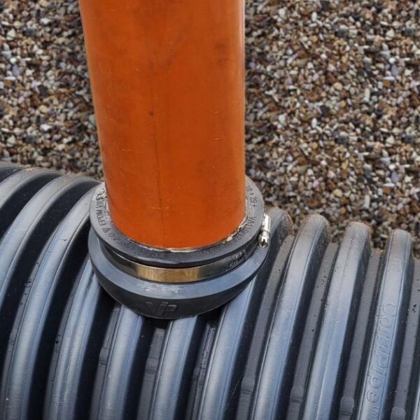 product image of 110mm twinwall pipe saddle adaptor installed with underground drainage pipe