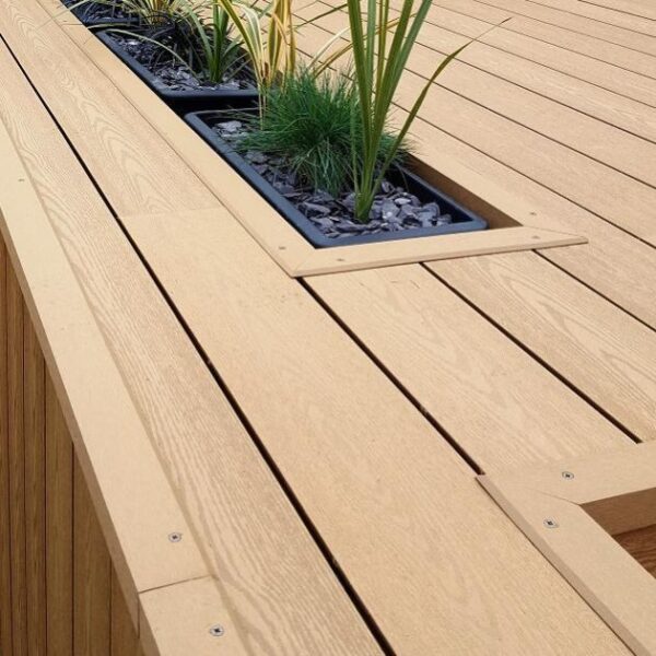photograph of hyperion explorer – composite decking corner trim in oak used on decking around planters