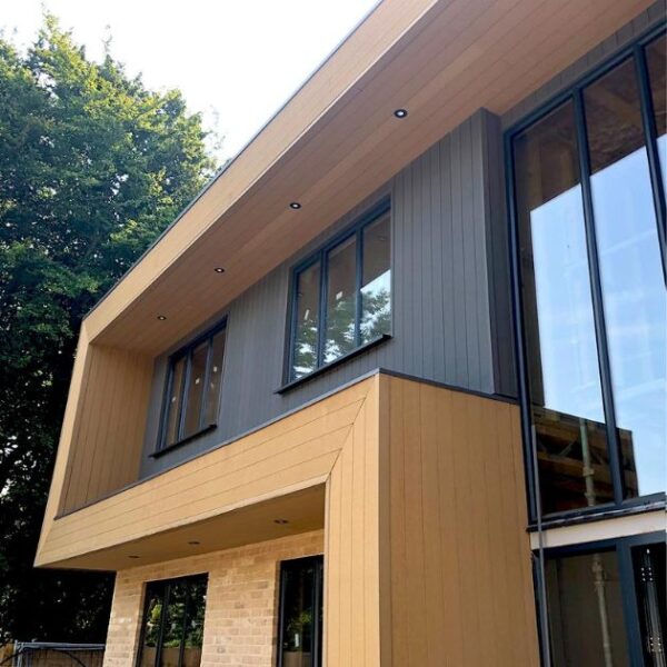 photograph of oak and granite hyperion explorer – composite decking corner trim installed on a house